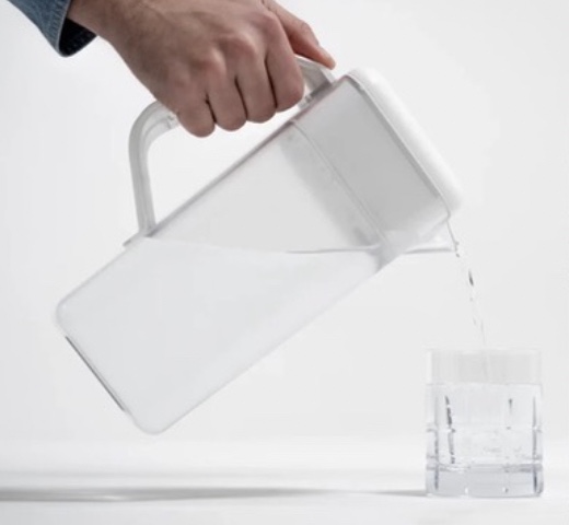 Pouring clean water from the Spout pitcher into a glass
