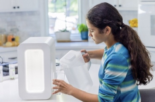 Pouring fresh water from the Spout Always Fresh Pitcher in a kitchen